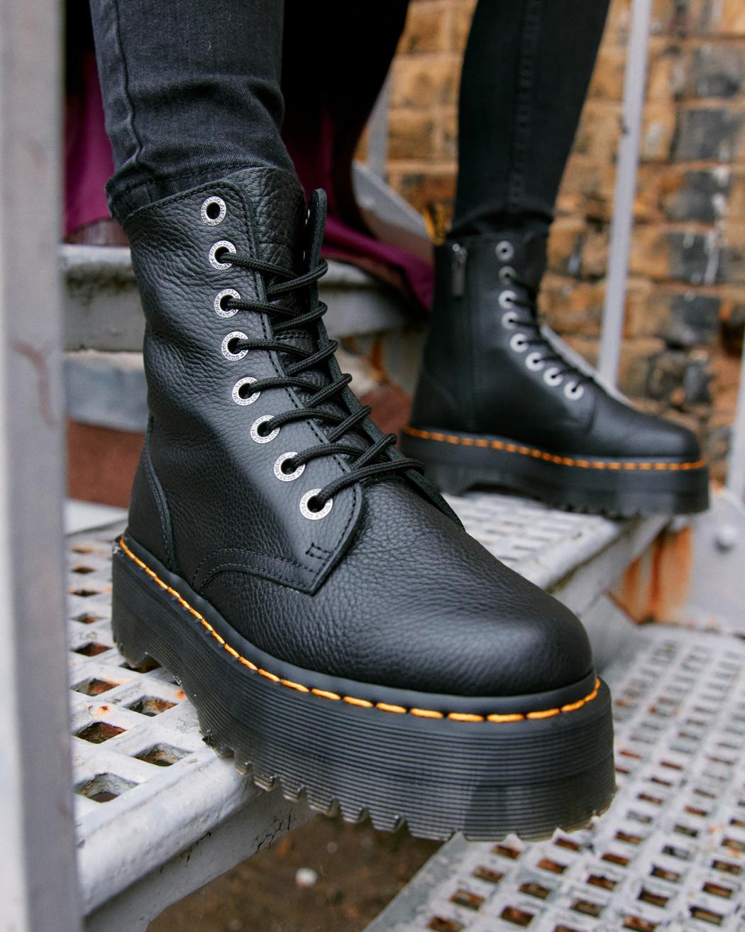 A mid-ankle height, laced, black leather platform boot.