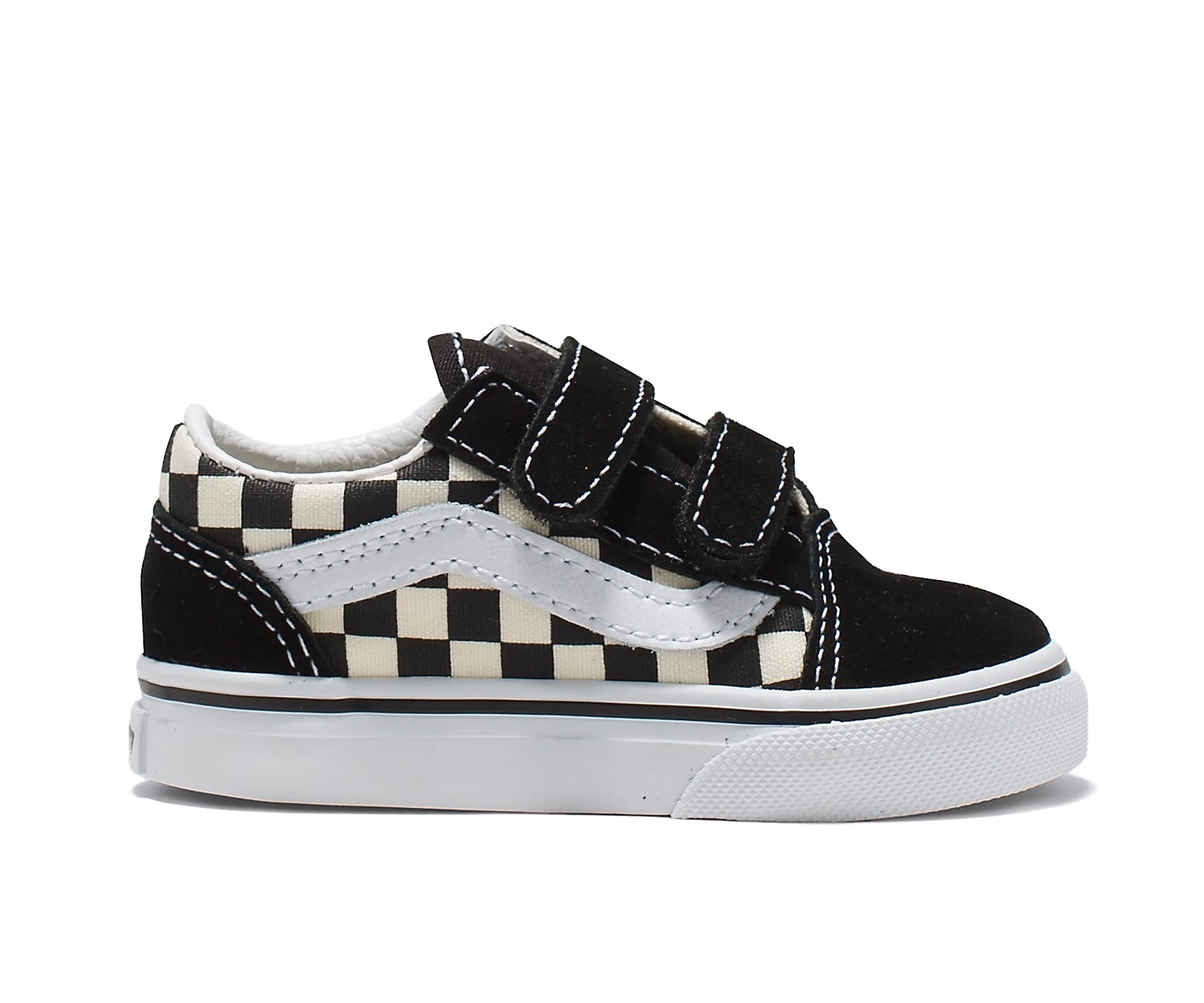 A checkerboard black and white canvas and suede kids' sneaker with velcro straps.